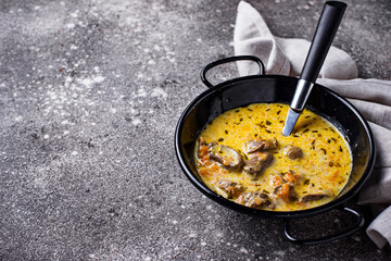 Stewed chicken heart in sour cream