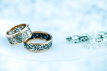 Wedding gold rings on white ribbon