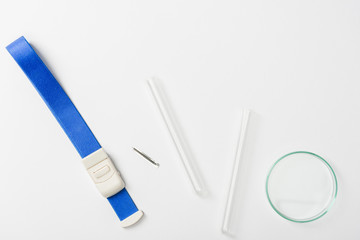 Top view of blue bandage and test tubes on grey background, blood donation concept