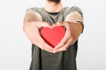 Cropped view of man in grey t-shirt holding paper heart