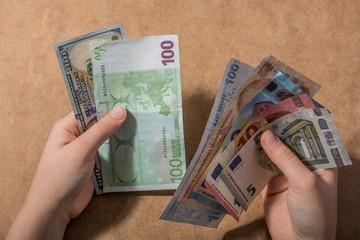 Hand holding American dollar  isolated on wooden background