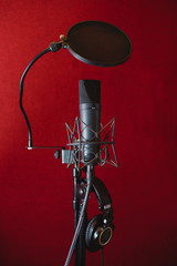 Microphone for recording music in the studio. Red background.