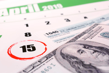 2019 calendar with 1040 income tax form for 2018 showing tax day for filing on April 15