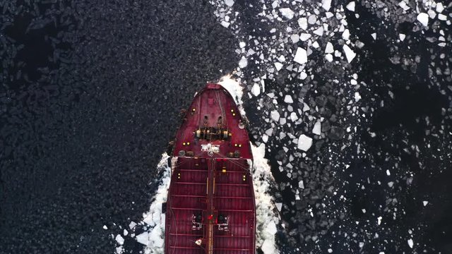 Top aerial view of ship nose floating through ice floes. Eastern Bosphorus strait, Russia