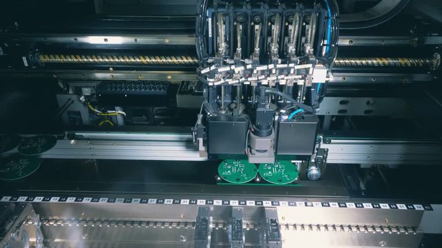 High-tech machine is chipping green round boards