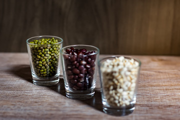 Cereals in glass cups placed on a wooden background