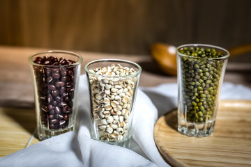 Cereals in glass cups placed on a wooden background