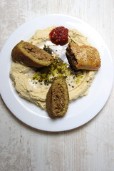 Prepared plate of kibbeh, bourek and hummus, middle eastern cuisine