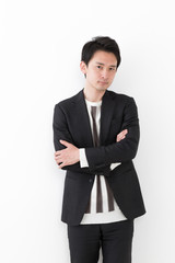 Obraz na płótnie Canvas portrait of young asian man wearing suit isolated on white background