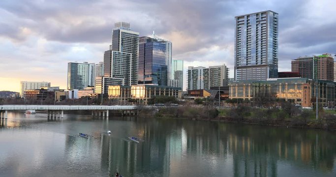 Austin Texas Sculling row boat team sunset river lake city. Brilliant sunset colors. Lady Bird Lake,  Town Lake is a river reservoir on Colorado River in Austin, Texas. Congress Bridge. Recreation.