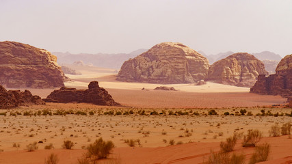 Wadi Rum desert, Jordan, Middle East, The Valley of the Moon. Orange sand, haze, clouds....