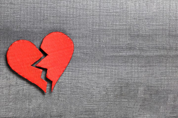 Broken heart on wooden table with copy space. Valentine's Day background