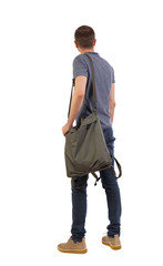 Back view of a man with a green bag.