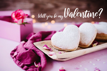 Valentine's greeting card with heart shaped donuts, roses and pink gift box