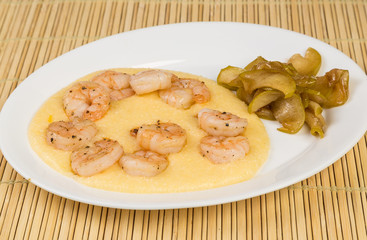 Sauteed Shrimp on Cheese Grits with Candied Apples on Bamboo Mat