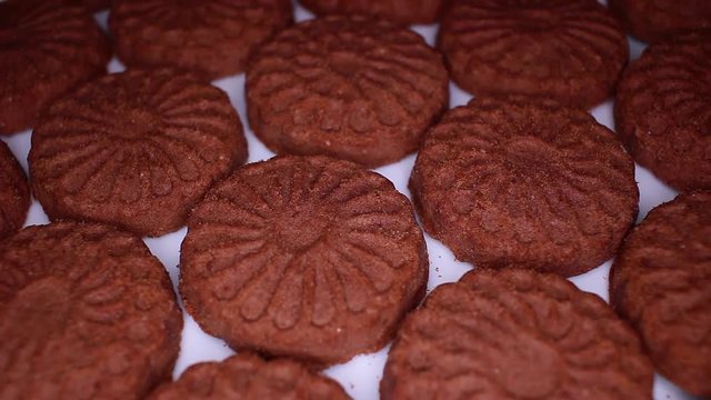 Chocolate biscuit brown chocolate biscuits cacao food closeup texture pattern. Seamless looping video footage