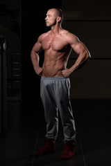 Obraz na płótnie Canvas Healthy Young Man Flexing Muscles