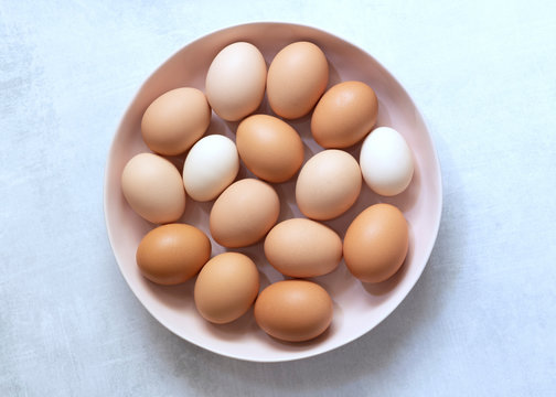 Brown and white eggs in a bowl.