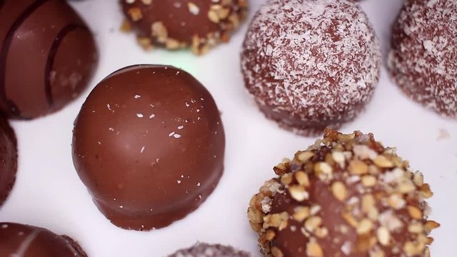Chocolate balls, ball bonbon bonbons chocolates food closeup texture pattern. Seamless looping video footage
