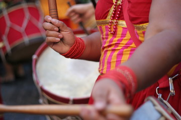Girl playing brazilian alfaia drum