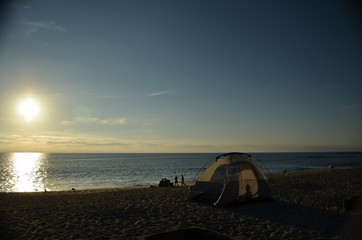 Camping on the beach at sunset