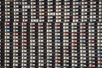 Fototapeta na wymiar new cars lined up in the parking lot for distribution international for business sale by large corgo container shipping open sea