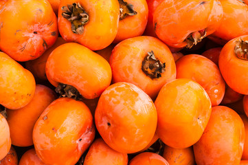 Fototapeta na wymiar The persimmon fruits closeup and background