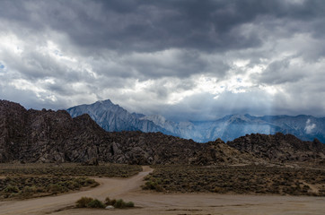 Fototapeta na wymiar Dirt roads in the Alabama Hills in Lone Pine California, as a downburst of rain moves through the area. Many Western classic movies were filmed here