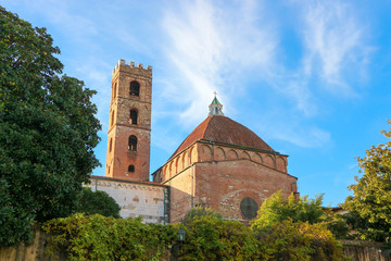 Fototapeta na wymiar The church of SS.Giovanni e Reparata back view with bell tower made from red brick and baptistery large dome on the blue sky background, Tuscany, Italy