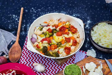 Baked, roasted, grilled vegetables on iron cast skillet with herbs and spices. Tomato, broccoli, cauliflower, potato, mushrooms, onion. Vegetarian dinner, vegan lunch, healthy food. Top above view.