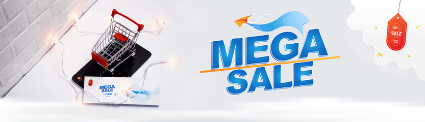 Online sale concept. Shopping cart and flyer with glowing lights on the tablet and on the background of a brick wall.