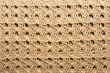 Abstract beige knitted fabric for background.Knitted texture.