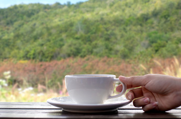 Coffee espresso on wood table nature background in garden,warm tone