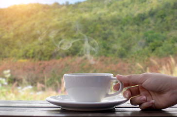 Coffee espresso on wood table nature background in garden,warm tone