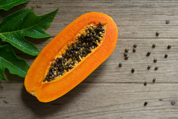 Papaya fruit on wooden background.Slices of sweet papaya on wooden background,Halved papayas