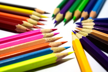 Multiple colored pencils on a white background.