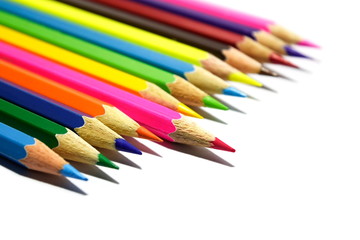 Multiple colored pencils on a white background.