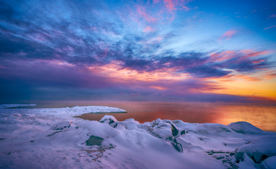 Beautiful sunrise clouds over horizon of frozen lake superior