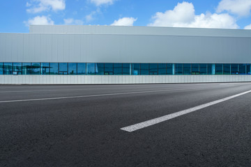 Road asphalt pavement and modern factory warehouse..