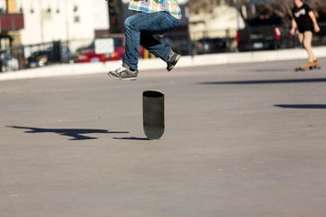 Person riding a skate board in an urban asphalt park