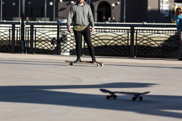 Person riding a skate board in an urban asphalt park