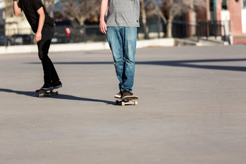 Person riding a skate board in an urban asphalt park
