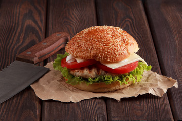 Tasty grilled home made burger with beef, tomato, cheese, cucumber and lettuce. With space for your recipe