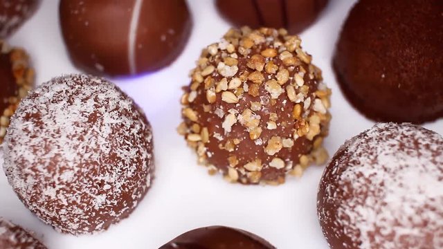 Chocolate balls, ball bonbon bonbons chocolates food closeup texture pattern. Seamless looping video footage