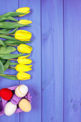 Bouquet of fresh tulips and Easter eggs wrapped woolen string, Easter decoration, place for text