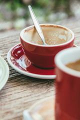 Empty coffee cup after drinking on wooden in cafe.
