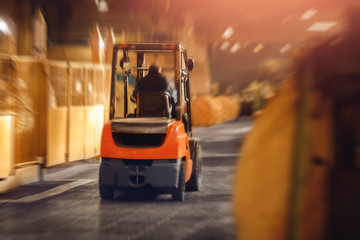 Warehouse industrial premises for storing materials and wood, forklift containers. Concept logistics, transport. Motionblur effect