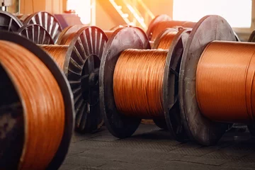 Foto op Plexiglas Production of copper wire, bronze cable in reels at factory © Parilov