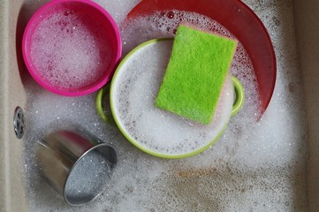 Washing dishes in the sink in the kitchen