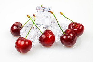 Obraz na płótnie Canvas Sweet cherries with ice cubes, yes against a white background